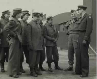 British Women's Land Army girls and their supervisor meeting Lt Griffin of the 44th Bomb Group at Shipdham Airbase. (Digital archive reference MC 371/046)